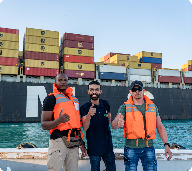 Marine support team standing beside a container ship